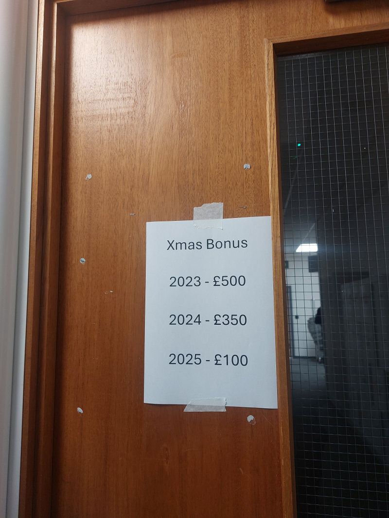 door poster showing decline in christmas bonus to £100