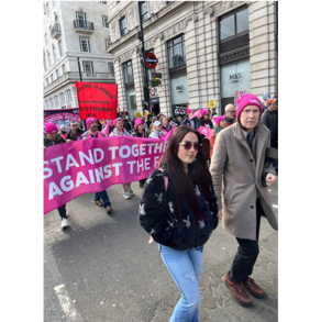keith and lara in front of a pink banner